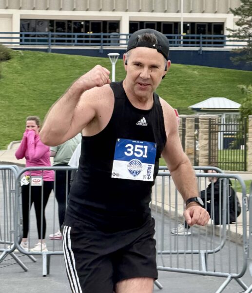 Neil Chryst, Shrader Tire & Oil Sales, finishing his 24th marathon at Glass City 2026