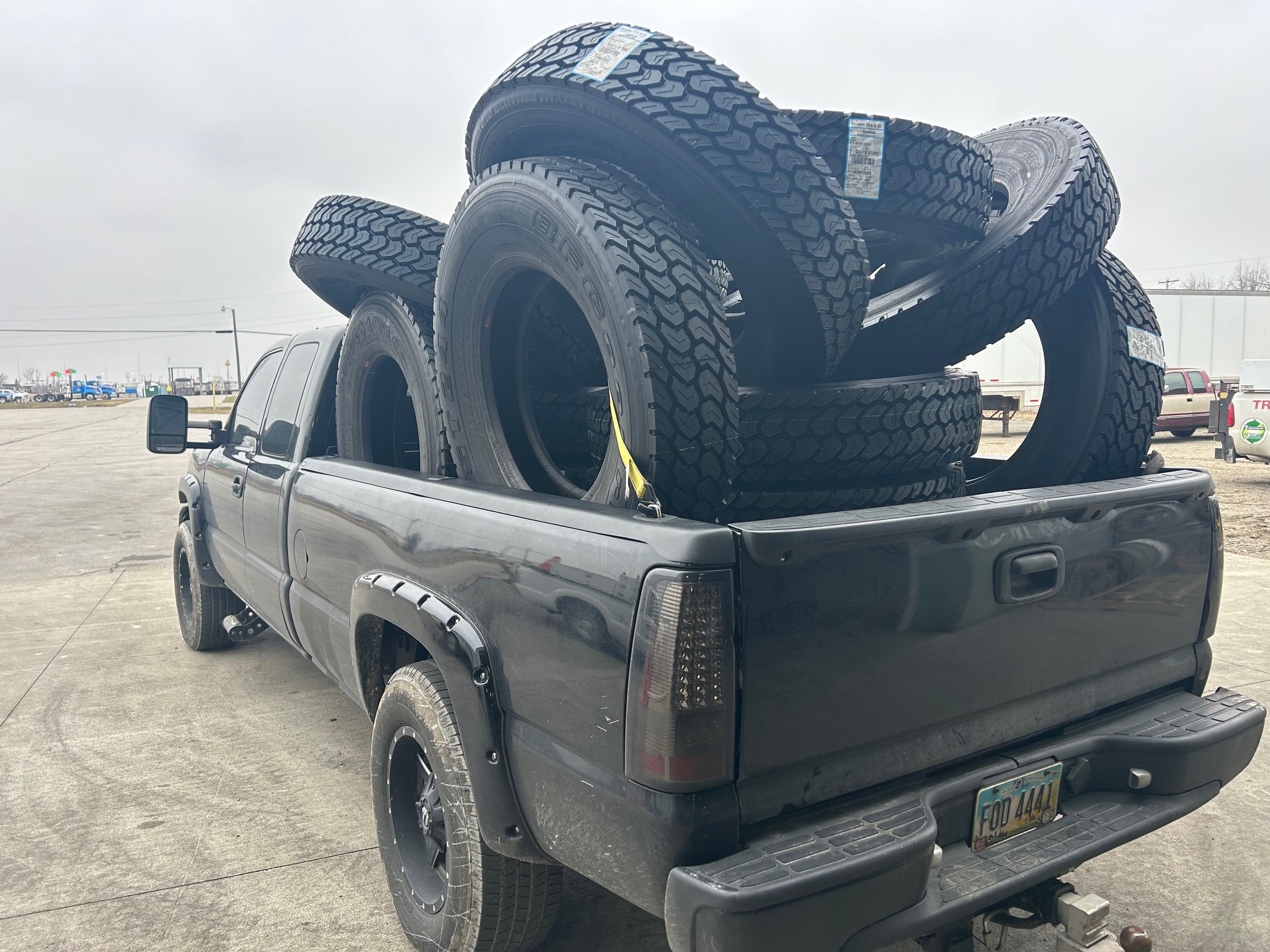 2007 Chevrolet Silverado truck bed loaded with commercial tires — Jim Muncy, Shrader Tire & Oil