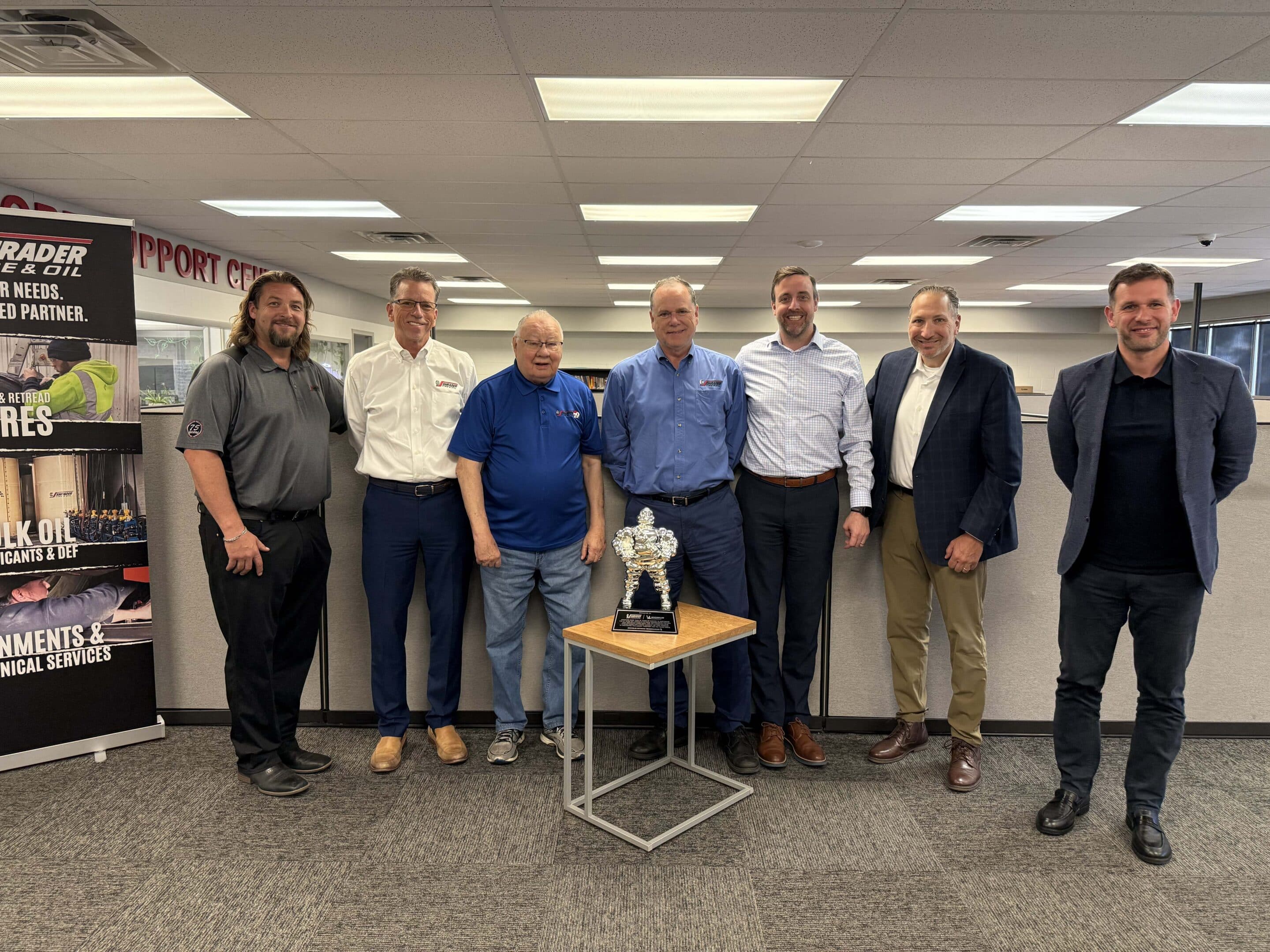 Shrader Tire & Oil leadership team gathered with the Michelin Retread Technologies Bibendum trophy at Toledo headquarters